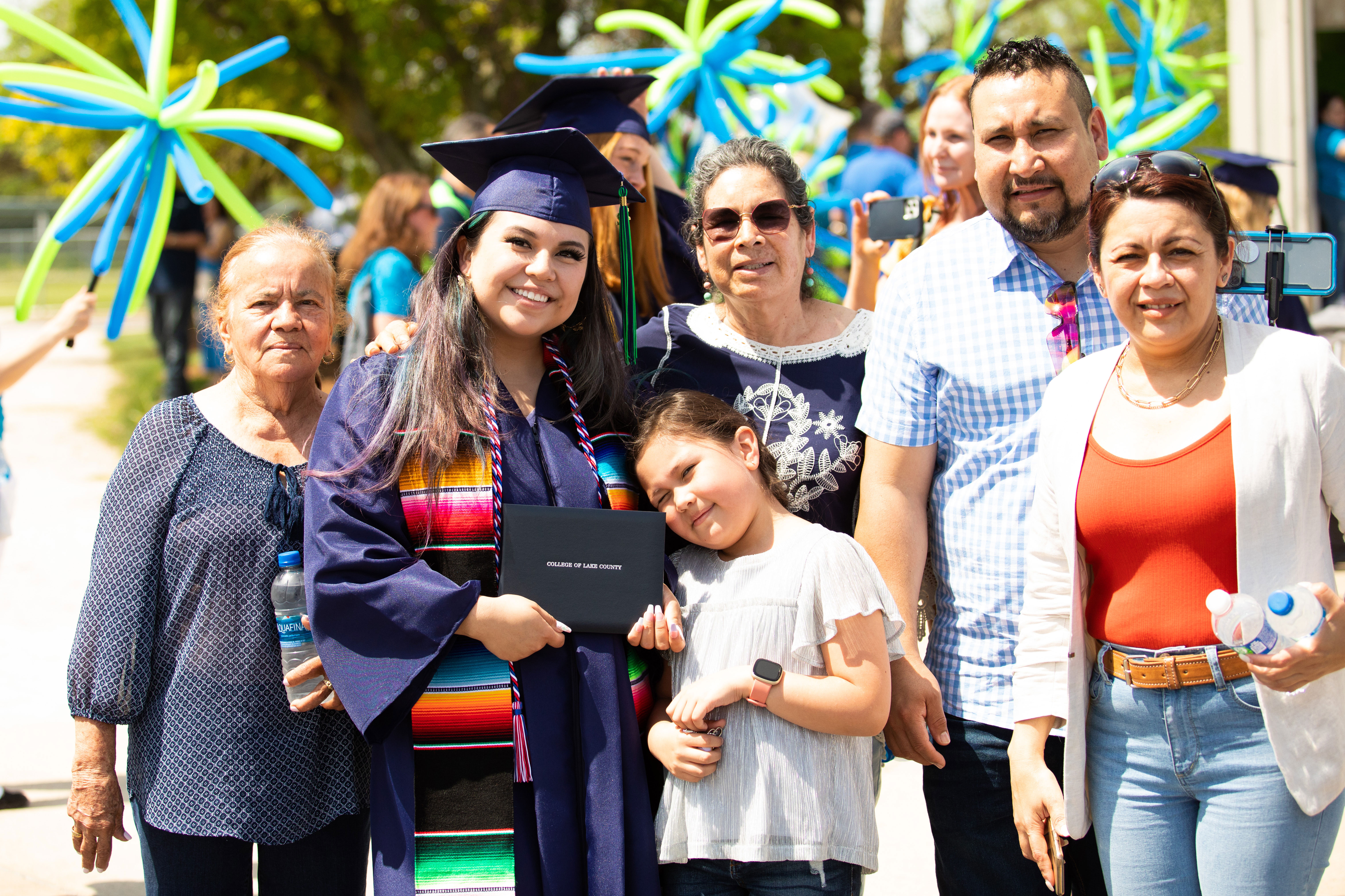 Latinx CLC graduate with her family