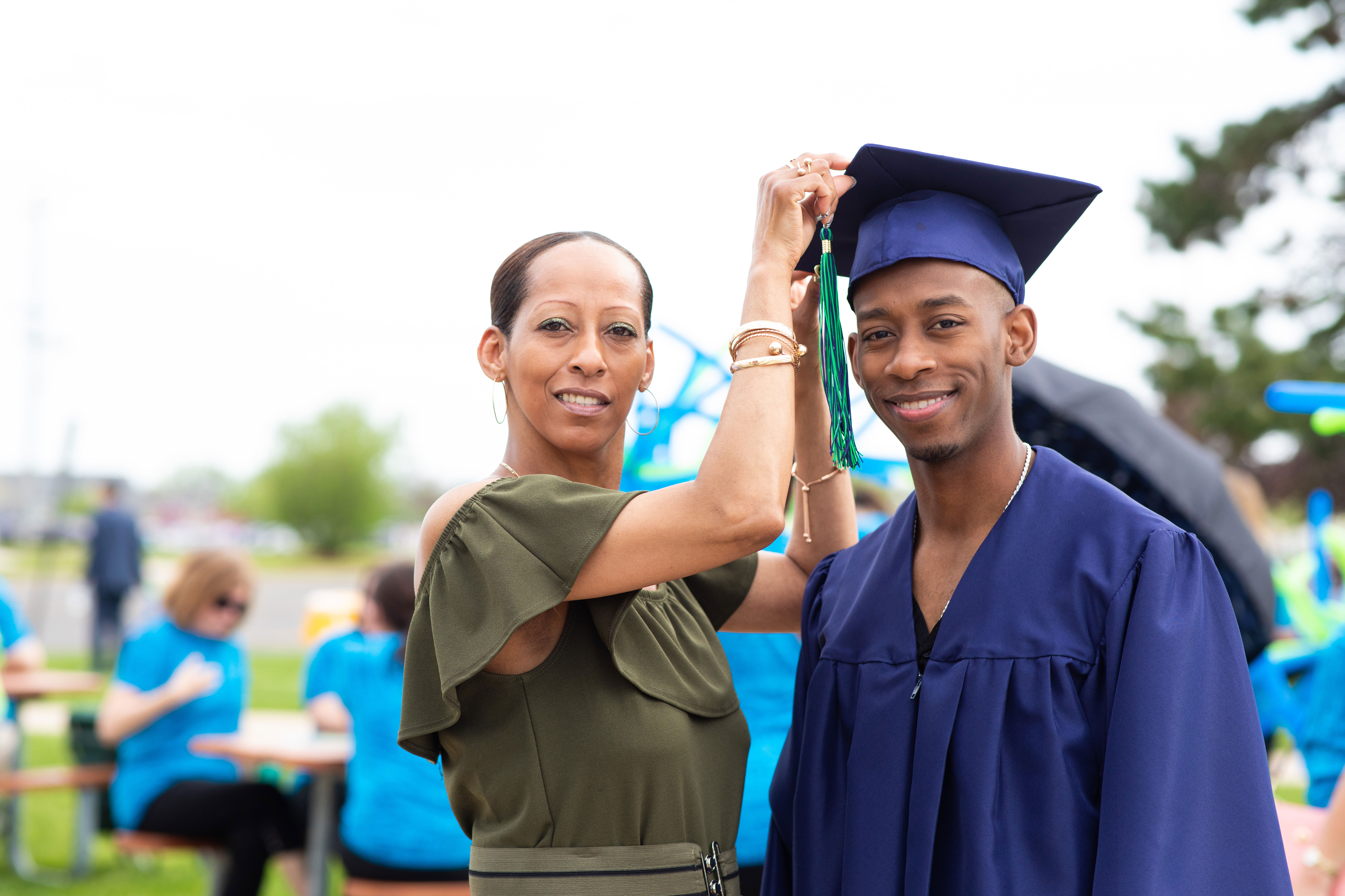 Black male graduate with his mom